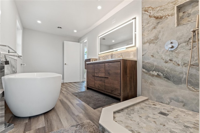 bathroom with vanity, separate shower and tub, and wood-type flooring