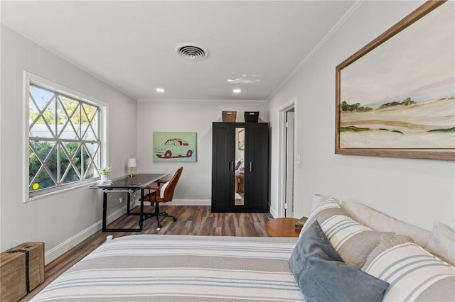 bedroom with crown molding and dark hardwood / wood-style flooring