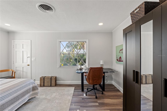 bedroom featuring ornamental molding, a textured ceiling, and dark hardwood / wood-style flooring