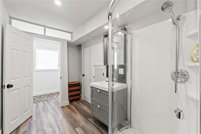 bathroom with an enclosed shower, vanity, and hardwood / wood-style flooring