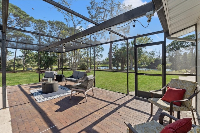 sunroom / solarium featuring a water view