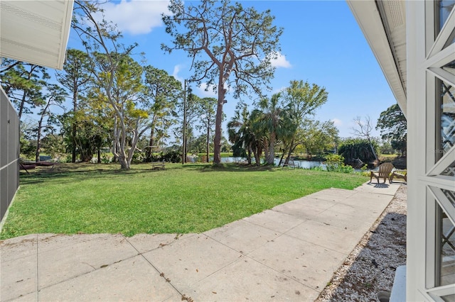 view of yard with a patio area and a water view