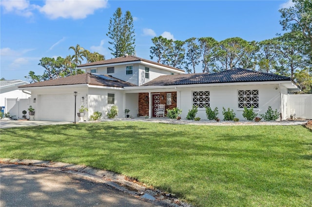 view of front facade with a garage and a front lawn