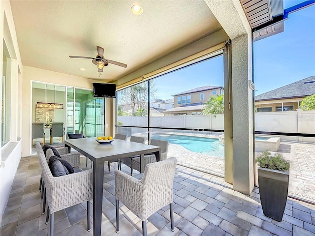 sunroom featuring ceiling fan