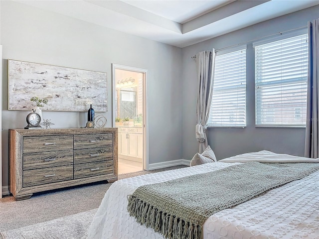 carpeted bedroom with ensuite bath