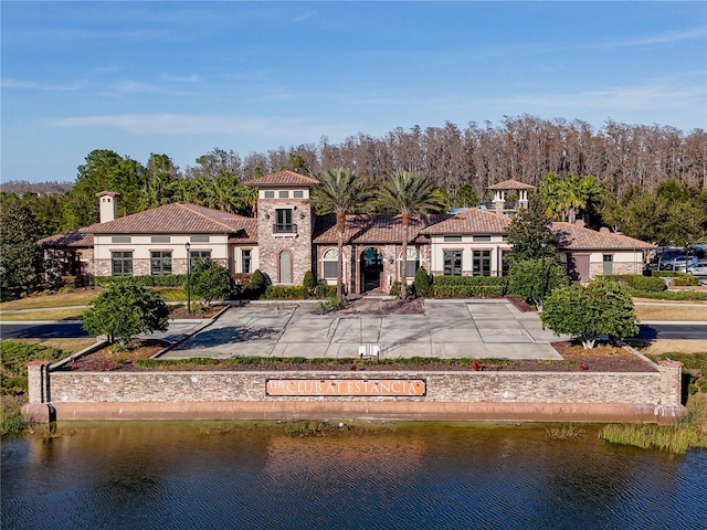 rear view of property with a water view