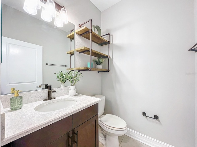 bathroom with vanity, tile patterned flooring, and toilet