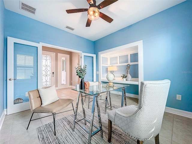 interior space with light tile patterned floors and ceiling fan