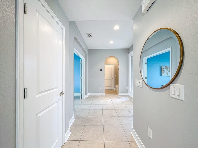 hall featuring light tile patterned floors