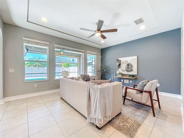 living room with light tile patterned floors and ceiling fan