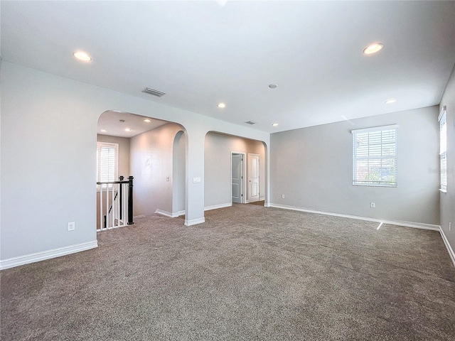 carpeted empty room with plenty of natural light