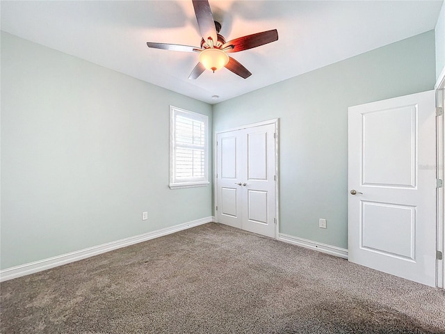 unfurnished bedroom with carpet flooring, ceiling fan, and a closet