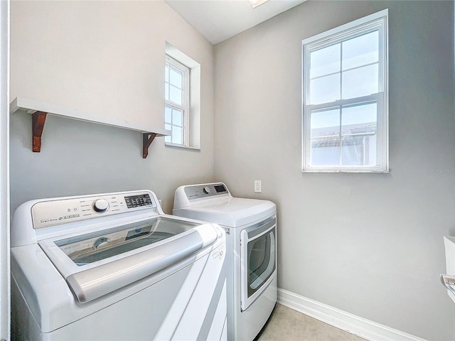 clothes washing area with washing machine and dryer