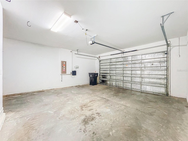 garage featuring a garage door opener and electric panel