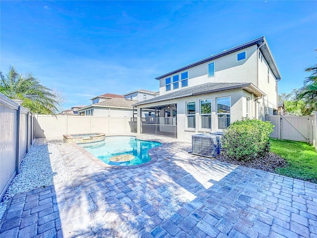 view of swimming pool featuring an in ground hot tub, central AC unit, and a patio