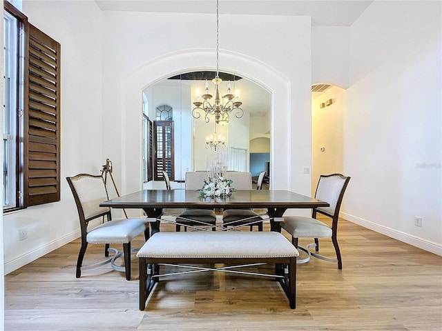 dining room featuring light hardwood / wood-style floors and a chandelier