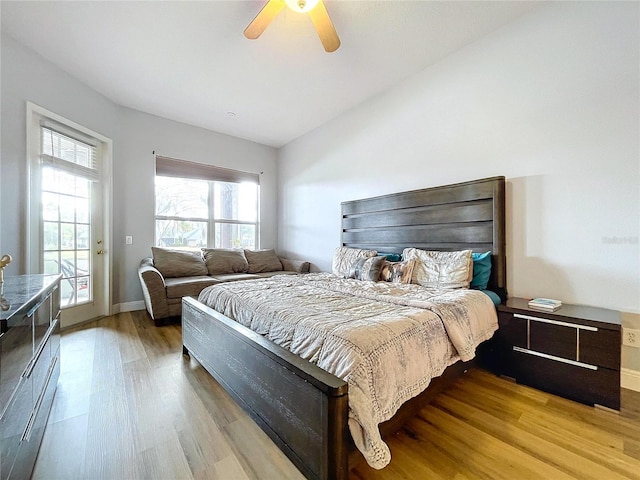 bedroom featuring ceiling fan, access to outside, vaulted ceiling, and light wood-type flooring