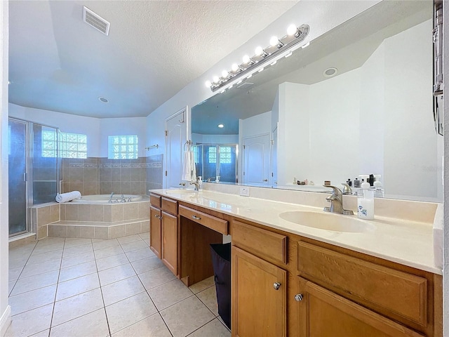 bathroom featuring vanity, separate shower and tub, tile patterned floors, and a textured ceiling