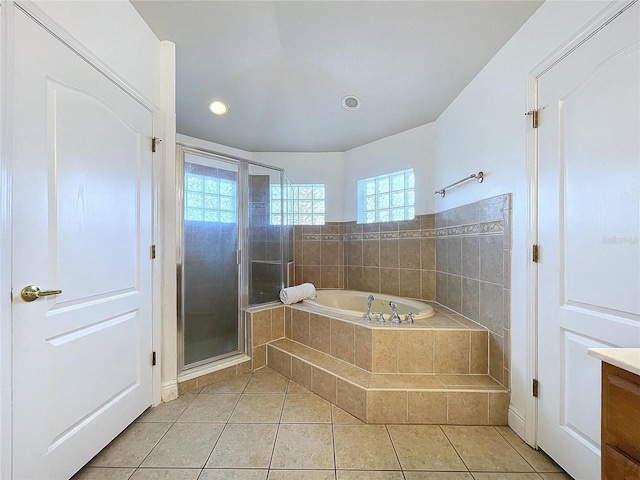 bathroom featuring vanity, separate shower and tub, tile patterned flooring, and a wealth of natural light