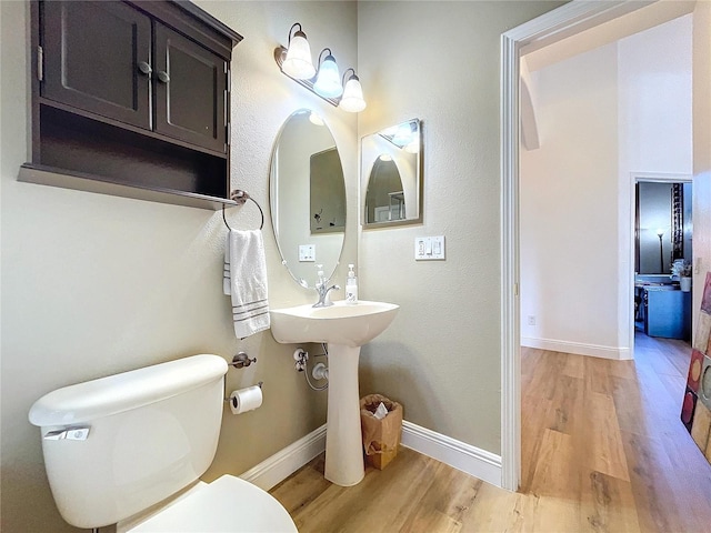 bathroom featuring toilet and hardwood / wood-style floors