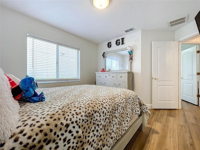 bedroom featuring light hardwood / wood-style floors