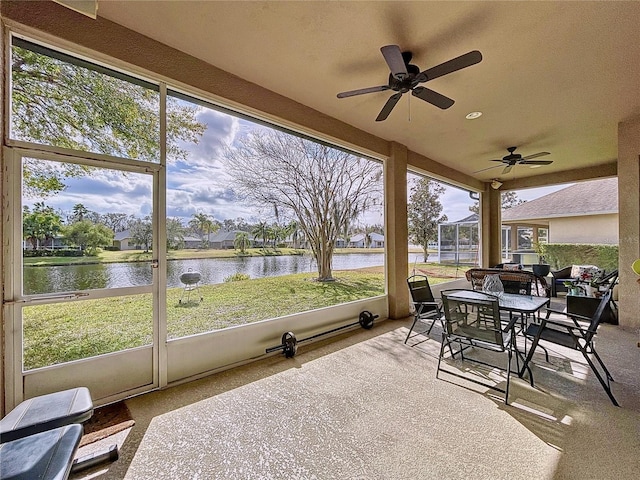 sunroom / solarium with a water view