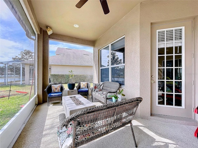 sunroom with plenty of natural light and ceiling fan