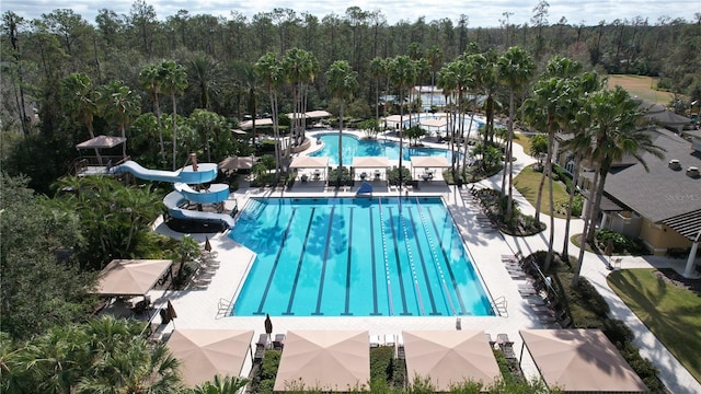 view of pool featuring a water slide and a patio area