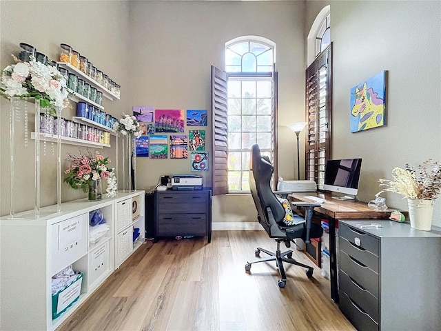 office space featuring light wood-style flooring and baseboards