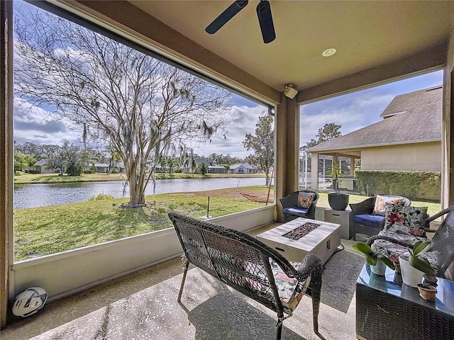 sunroom / solarium featuring a wealth of natural light and a water view