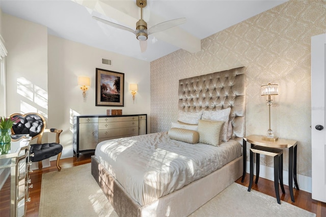 bedroom with hardwood / wood-style flooring and beamed ceiling