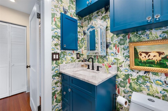 bathroom with vanity, hardwood / wood-style floors, and toilet