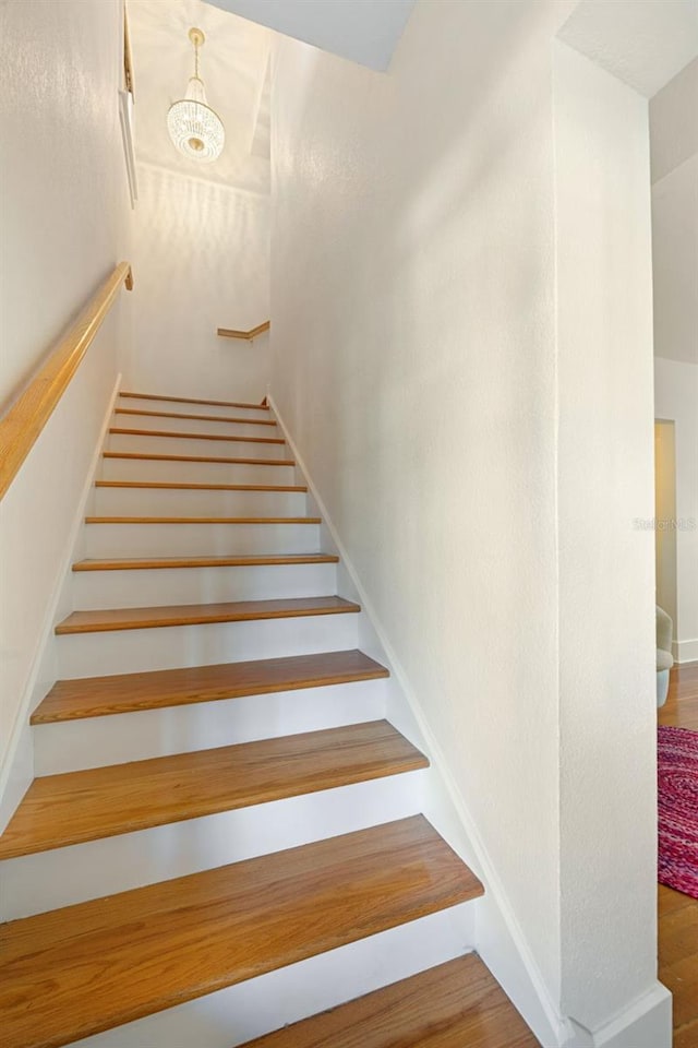 stairs featuring wood-type flooring