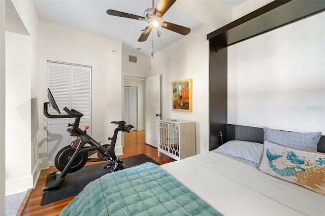 bedroom with vaulted ceiling, ceiling fan, hardwood / wood-style floors, and a closet