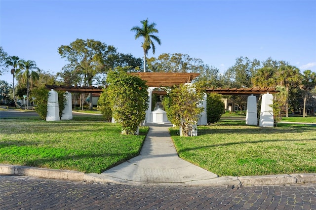 view of home's community with a yard and a pergola