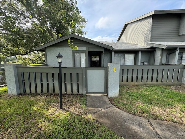 view of front of property featuring a fenced front yard and stucco siding