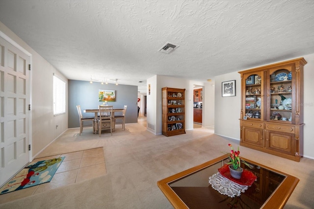 living room with light carpet and a textured ceiling