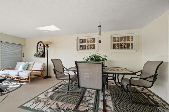 dining room with light tile patterned floors and a textured ceiling