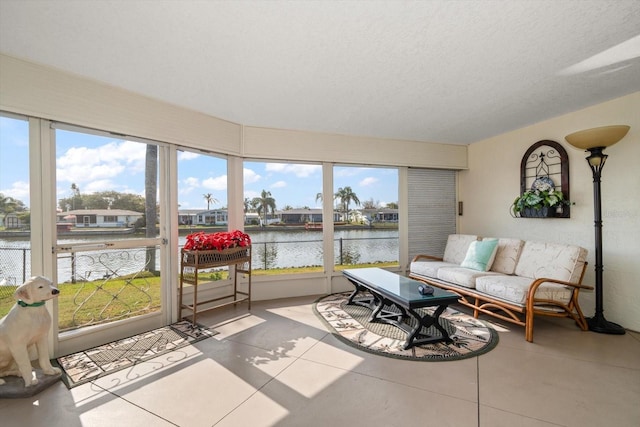 sunroom / solarium featuring a water view