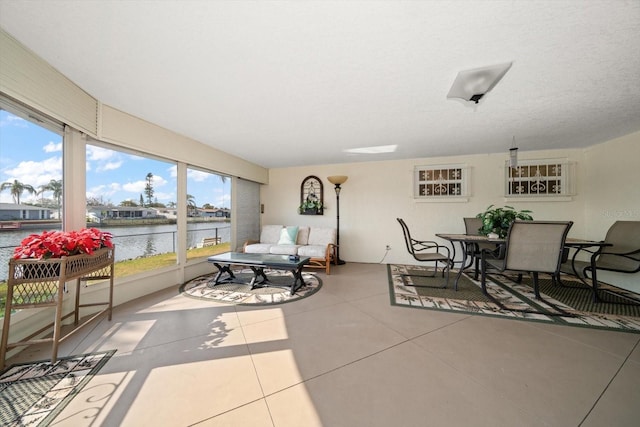 sunroom / solarium featuring a water view