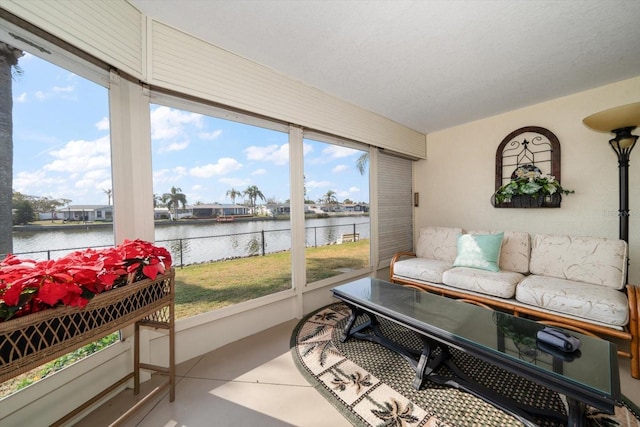 sunroom featuring a water view