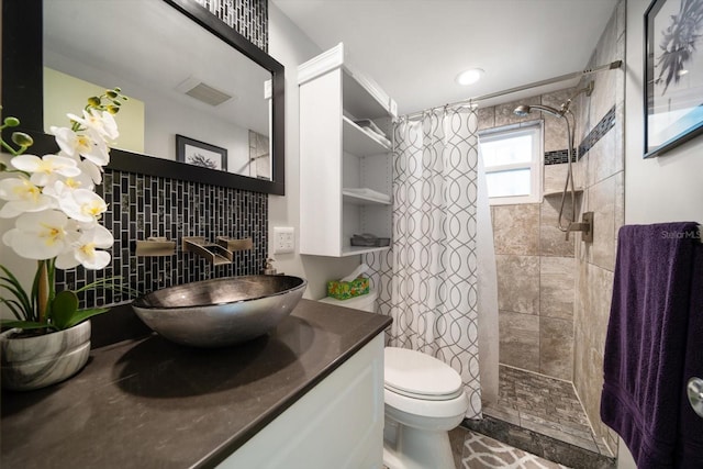 bathroom with toilet, vanity, backsplash, and a shower with curtain