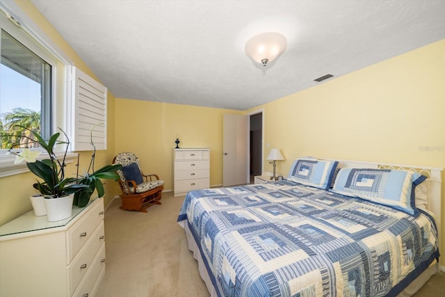 carpeted bedroom featuring a textured ceiling