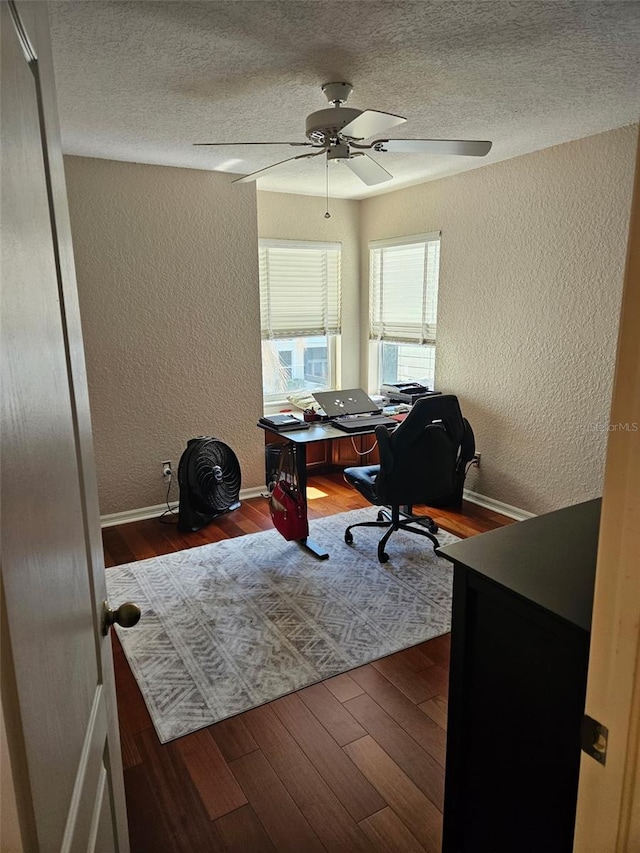 office featuring hardwood / wood-style flooring, ceiling fan, and a textured ceiling