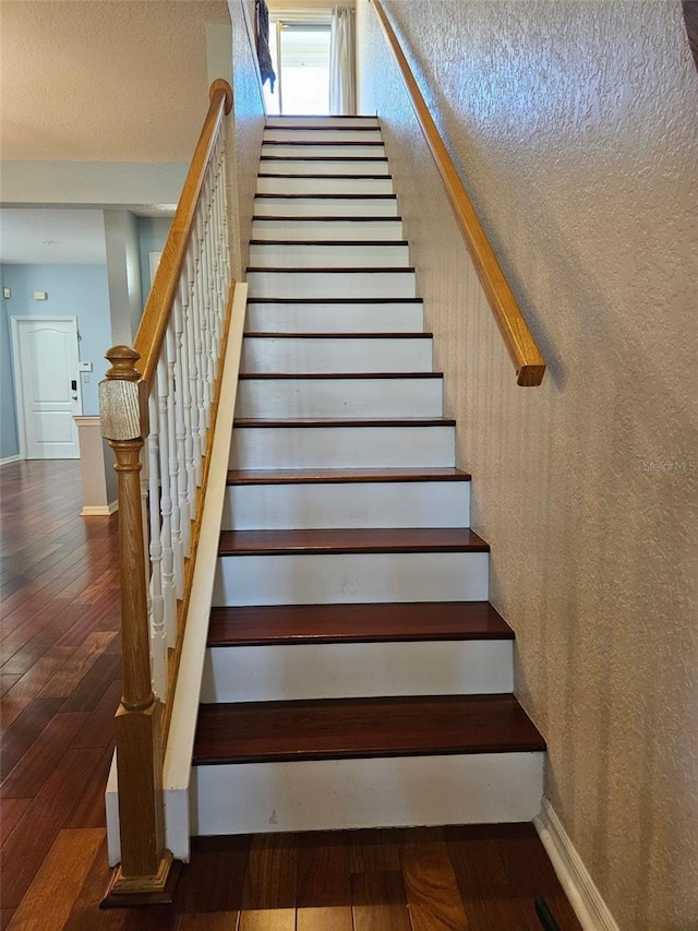 stairs featuring wood-type flooring