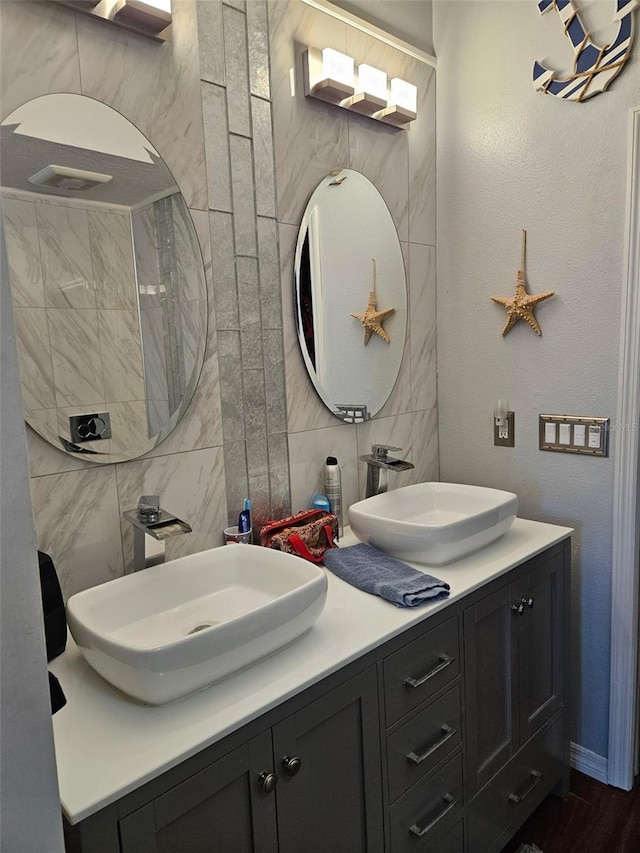 bathroom with vanity, tile walls, and backsplash