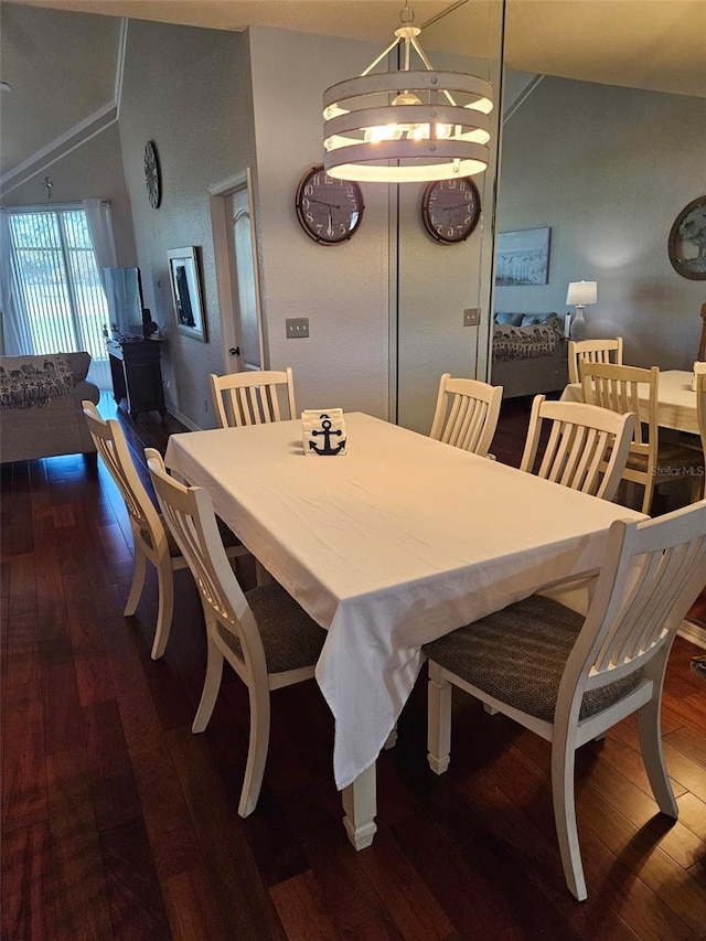 dining area with dark hardwood / wood-style flooring and vaulted ceiling