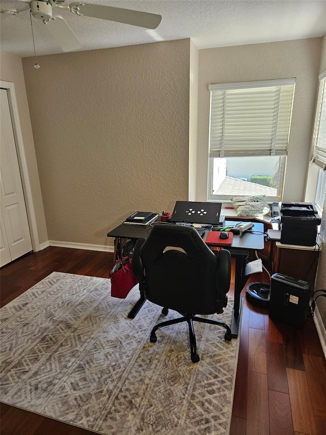 office with ceiling fan and dark hardwood / wood-style flooring