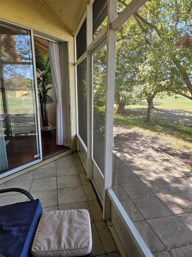 unfurnished sunroom featuring lofted ceiling