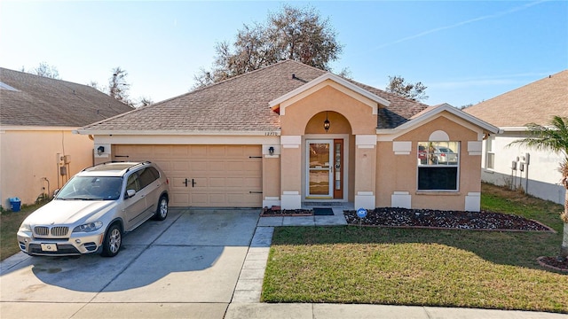 ranch-style home featuring a garage and a front lawn